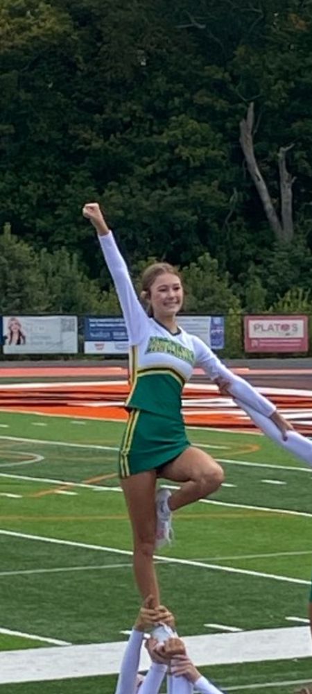 Emmalyn cheering on the field for Little Miami