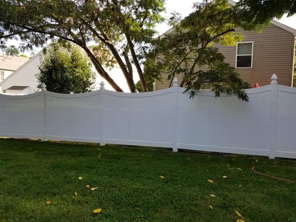 The same vinyl privacy fence clean and bright white after soft washing by Osborne Pro Wash